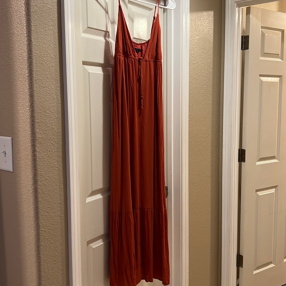Rust colored maxi dress with adjustable straps.